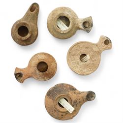 A group of five ancient terracotta oil lamps – Eastern Mediterranean (c.2nd century B.C.-1...