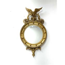Reproduction Regency style gilt wall mirror, the eagle and leaf scroll pediment over circular mirror plate