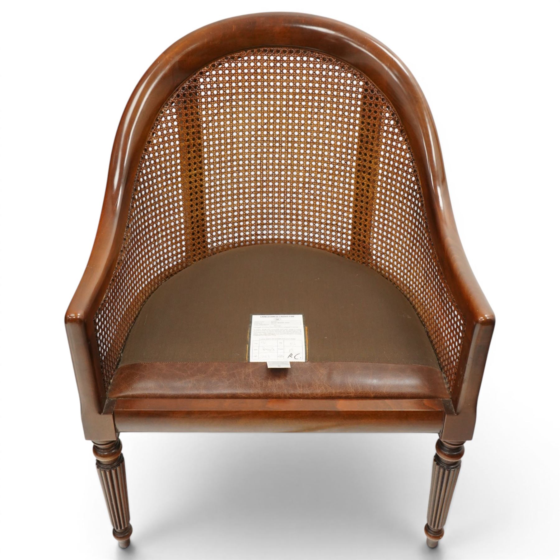 Laura Ashley - pair of bergère tub armchairs with leather seats, raised on fluted and turned supports