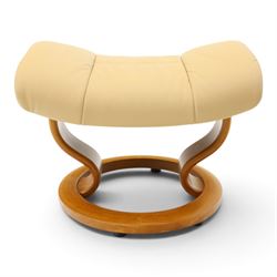 Ekornes Stressless - beech framed reclining swivel armchair with matching footstool, on U-shaped supports with circular bases, upholstered in beige leather
