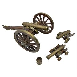 Large model brass cannon, upon wooden base, together with two similar smaller cannons, largest L48cm