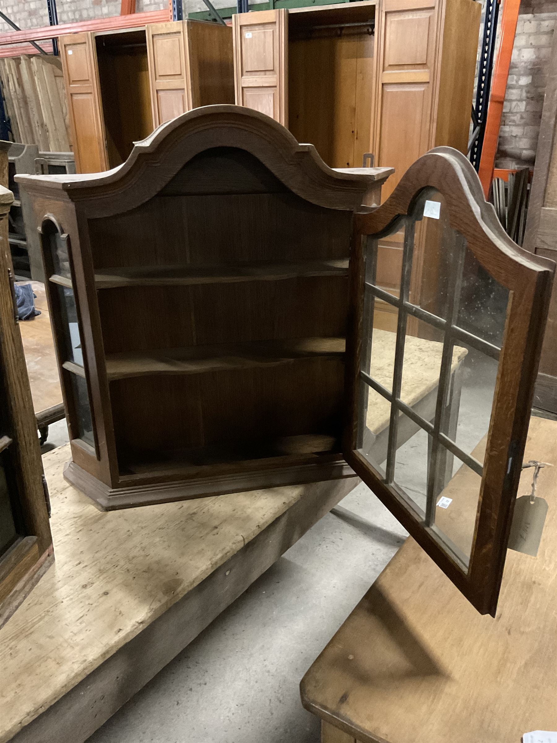 Dutch design oak wall hanging apothecary cabinet, of arched form with single astragal style glazed door enclosing single shelf (W69cm D18cm H69cm); together with another similar of corner form (W75cm D48cm H69cm) - THIS LOT IS TO BE COLLECTED BY APPOINTMENT FROM THE OLD BUFFER DEPOT, MELBOURNE PLACE, SOWERBY, THIRSK, YO7 1QY