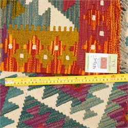 Afghan Maimana flatweave kilim runner, central field features large bold nested diamond motifs and stylized geometric lozenge patterns on olive purple, ochre, blue, and green tone ground, border stripe in orange and crimson ground, and fringe