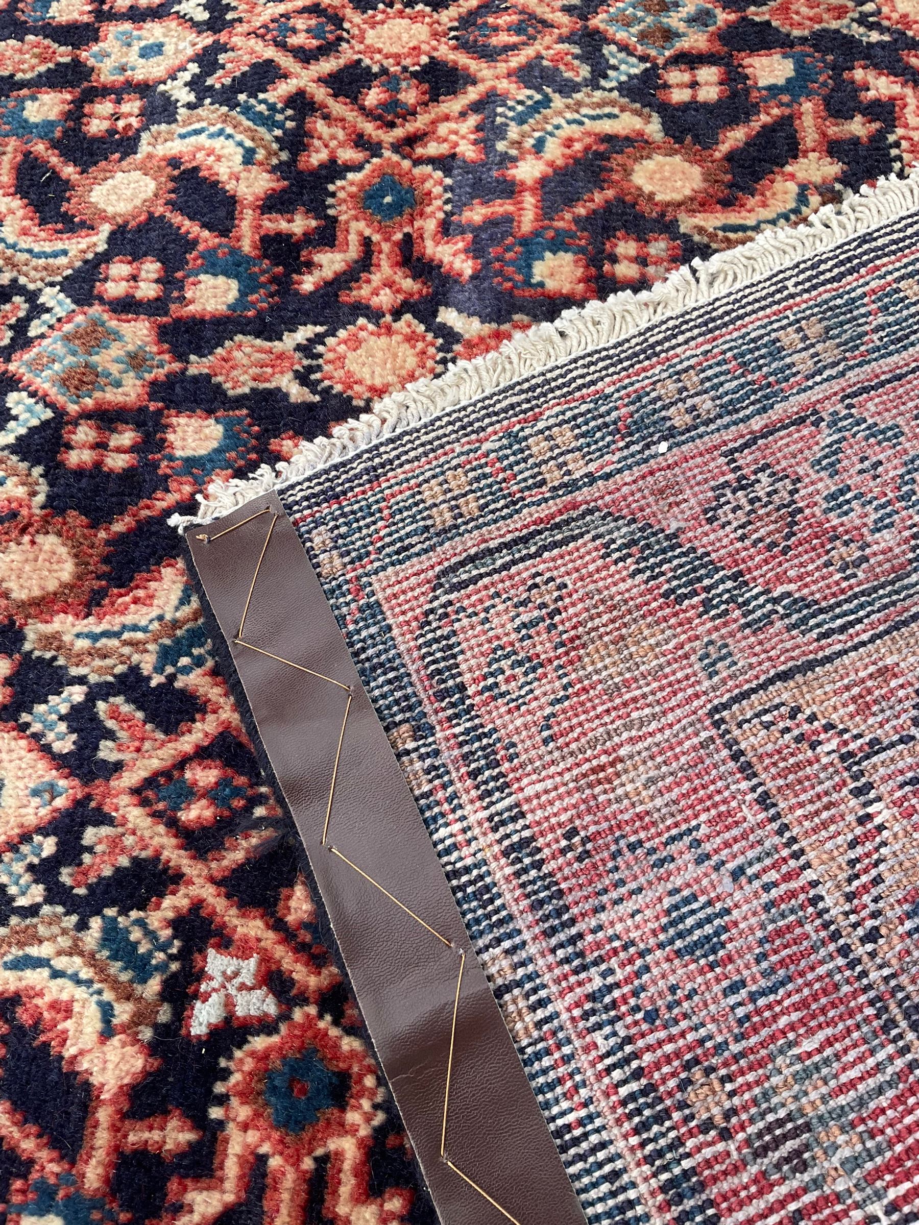 North West Persian Mahal indigo ground runner rug, the field decorated with all-over crimson Herati motifs, the guarded border with trailing geometric designs