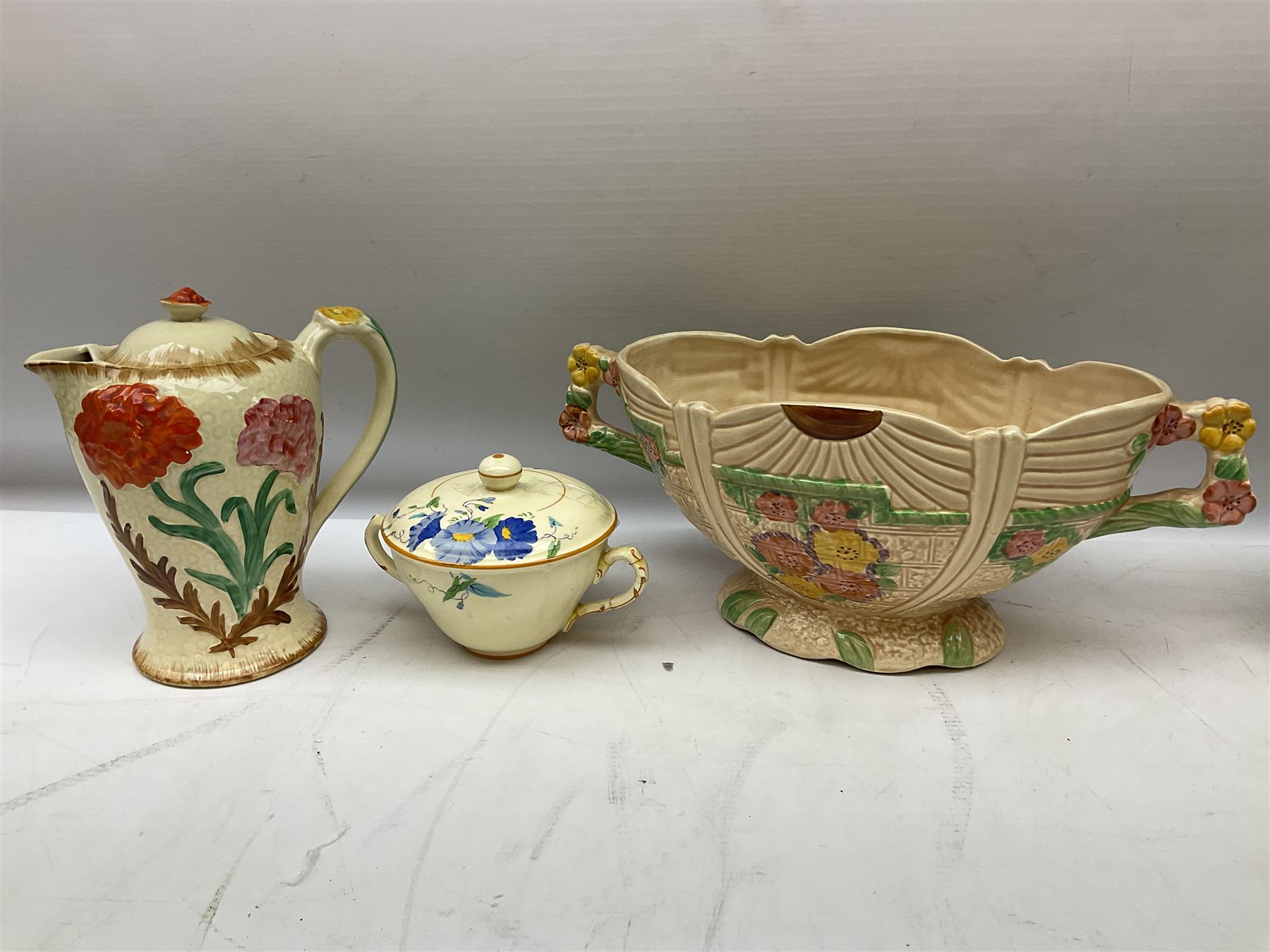 Group of ceramics to include Art Deco examples, Arthur Wood twin handled vase decorated in the Garden Wall pattern, Art Deco style Coalport twin handled lidded sucrier and saucer, Mason's Applique jug (scratch through mark), Royal Doulton Minden bowl and jug, Copeland Spode Royal Jasmine jug, Crown Devon, etc