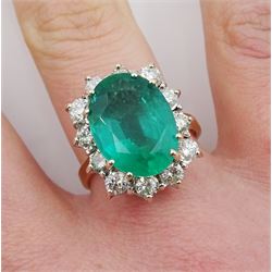 18ct gold oval emerald and round brilliant cut diamond cluster ring, hallmarked, emerald approx 5.90 carat, total diamond weight approx 1.40 carat