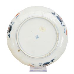 Group of 19th century Japanese Imari porcelain, Meiji period, comprising pair of lobed dishes, decorated stylised reserves and painels in blue and gilt upon a red ground, H6.5cm D21.5cm, a pair of plates of circular lobed form, decorated with a central panel depicting a vase beneath pine branches, and surrounded by panels of flowers and stylised quatrefoil shapes, D21cm, and another similar example painted with a character in underglaze blue to the centre, with character mark beneath, D22cm, each with character marks beneath               