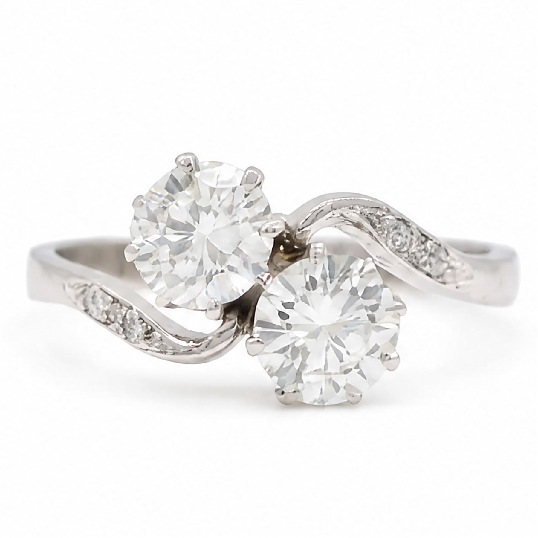 Platinum diamond crossover ring, set with two round brilliant cut diamonds and diamond set shoulders, Birmingham assay mark, total diamond weight approx 1.45 carat