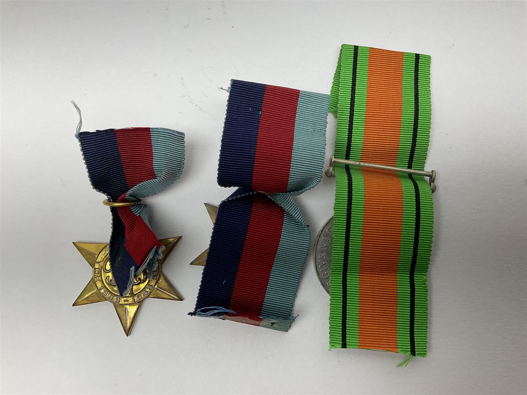 Twelve WW2 medals comprising four 1939-1945 war medals, four Defence medals, three 1939-1945 Stars and Africa Star; all with ribbons; some as groups in two issue boxes with slips