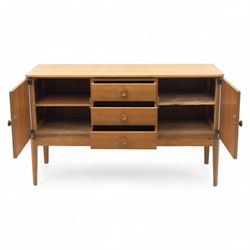 Gordon Russell - mid century modern teak sideboard, the rectangular top with rounded edges over twin cupboards and three central drawers, fitted with circular wooden pulls, on tapered supports, reflecting the firm’s commitment to simplicity and quality materials during the post-war design period