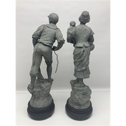 Pair of 20th Century spelter figures modelled as a Fisherman and Fisher's Wife, each mounted to a fixed stepped circular base, H60cm