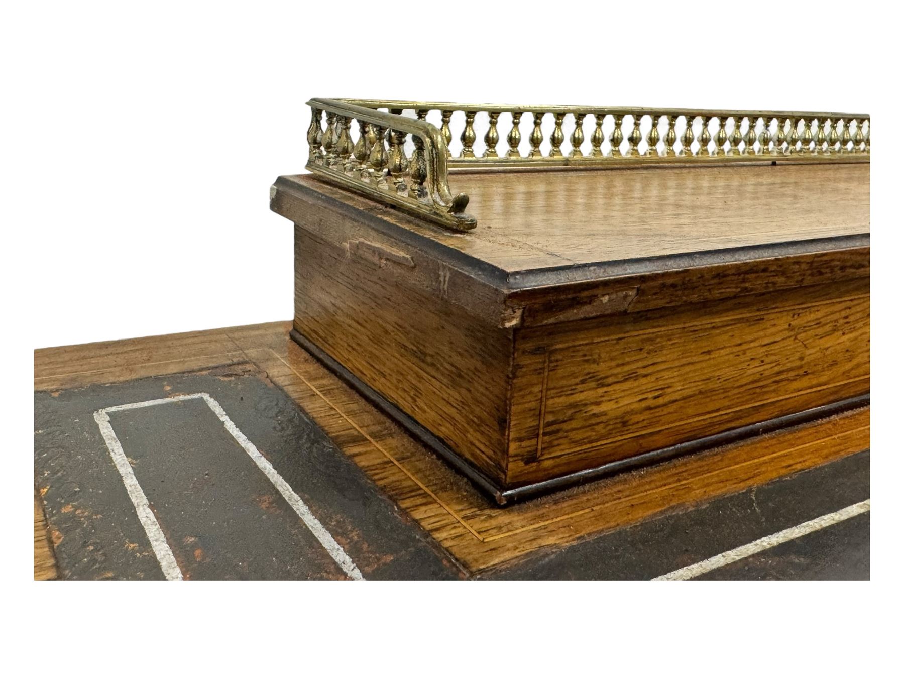 Late Victorian walnut writing table, rectangular leather-inset top surmounted by a brass gallery, fitted with a single frieze drawer, raised on turned tapering supports with lower undertier and ceramic castors