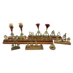 Brass horse terrets, many mounted on wood, including four examples with plumes