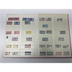 Mostly Great British stamps, including King Edward VII two shillings and sixpence, five shillings and ten shillings, King George V seahorses, King George VI high values, Queen Elizabeth II pre and post decimal etc, housed in a pink stockbook 