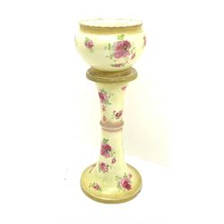 An early 20th century ceramic jardinière on stand, each decorated with pink roses upon a yellow ground, overall H93cm.