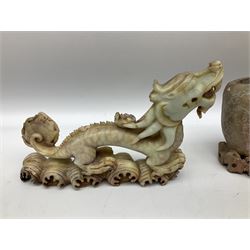 Three soapstone carvings, to include three toed dragon example, carved example with monkeys and another similar, together with carved wood figure, largest L29cm 
