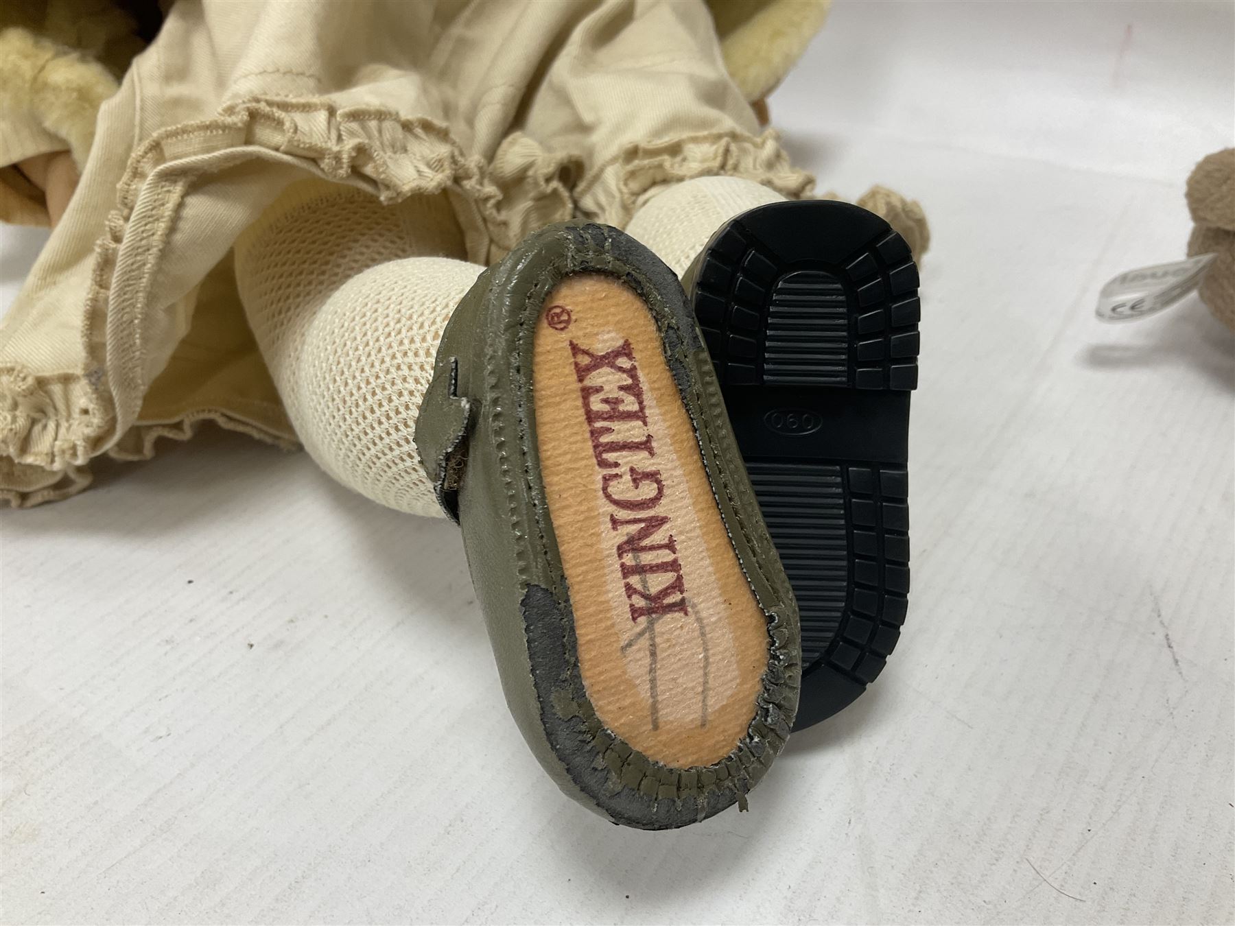 Two Zapf Creation limited edition designer collection dolls, by Brigette Paetsch, the first example with faux suede jacket, red jumper and denim skirt, no. 460, the second example 'Linda' in white dress with teddy bear accessory, no. 785, each signed B Paetsch, tallest L60cm