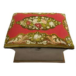 19th century upholstered ottoman, rectangular waisted form with hinged lid, upholstered in needle work cover decorated with floral panels and borders, the interior lined in blue fabric, lower moulded edge over compressed bun feet