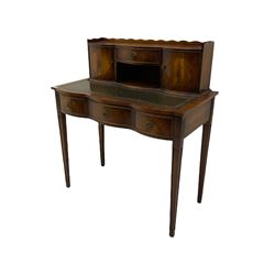 Mahogany writing desk, raised back fitted with two cupboards and drawer, serpentine top with leather inset over three drawers, square tapering supports
