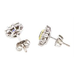 Pair of 18ct white and yellow gold oval cut sapphire and round brilliant cut diamond cluster stud earrings, London 1991, total sapphire weight approx 0.60 carat, total diamond weight approx 0.60 carat
