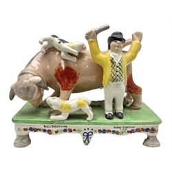 Staffordshire style figure 'Bull Beating, Now captain lad', modeled in the form of the bull being attacked by two terriers, the captain with arms raised, H15cm