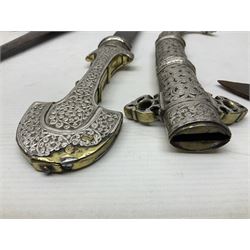 Moroccan jambiya dagger with 24.5cm plain curved blade stamped LONDON to the ricasso area, the hilt and scabbard overlaid with plain sheet brass to the back and ornate silver coloured metal to the front; waisted grip and arched pommel; two pyramid mounts to the scabbard L41cm overall; large billhook with curving blade and stacked leather washer grip; and a reproduction halberd blade (3)