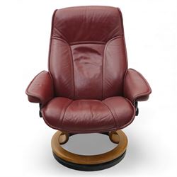 Ekornes - 'Stressless' maroon leather reclining swivel armchair, with high padded back and panel-stitched upholstery, shaped armrests, on a circular laminated wood swivel base