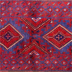 Afghan Meshwani runner, hand-knotted wool pile, indigo ground decorated with a vertical series of angular diamond medallions in tones of madder red, dark blue, framed by geometric borders with flatwoven kilim ends with fringe 