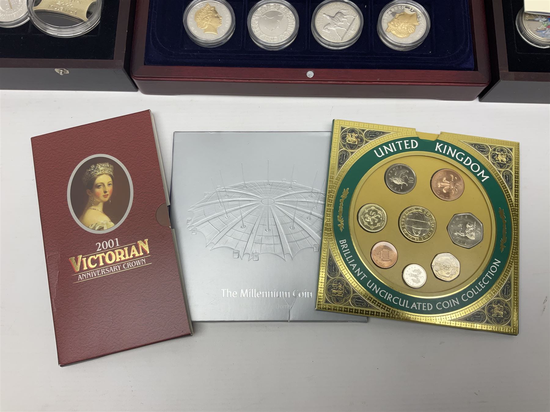 Single owner lifetime collection of mostly commemorative modern World coins with gold, silver and base metal examples, including two Queen Elizabeth II Bailiwick of Guernsey twenty-five pound gold coins 'The 1999 Royal Wedding' and '100th Anniversary of the End of the Victorian Era' 2001 each in 24 carat gold weighing 7.81 grams with certificates, silver coins commemorating the Millennium 2000 including Guyana sterling silver proof two-thousand dollars, Fiji sterling silver proof five dollars etc, silver coins from the Queen Elizabeth II Golden Jubilee Collection dated either 2002 or 2003 from Great Britain and the Commonwealth countries, United Kingdom commemorative crowns in card folders, The Royal Mint United Kingdom 1997 proof coin set in red folder without certificate etc