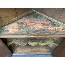 Large George III oak corner cupboard, projecting cornice over two stepped arch doors with fielded panels and blind fret work spandrels, flanked by fluted uprights, cupboard below enclosed by two fielded panel doors, the painted interior fitted with shaped shelves
 