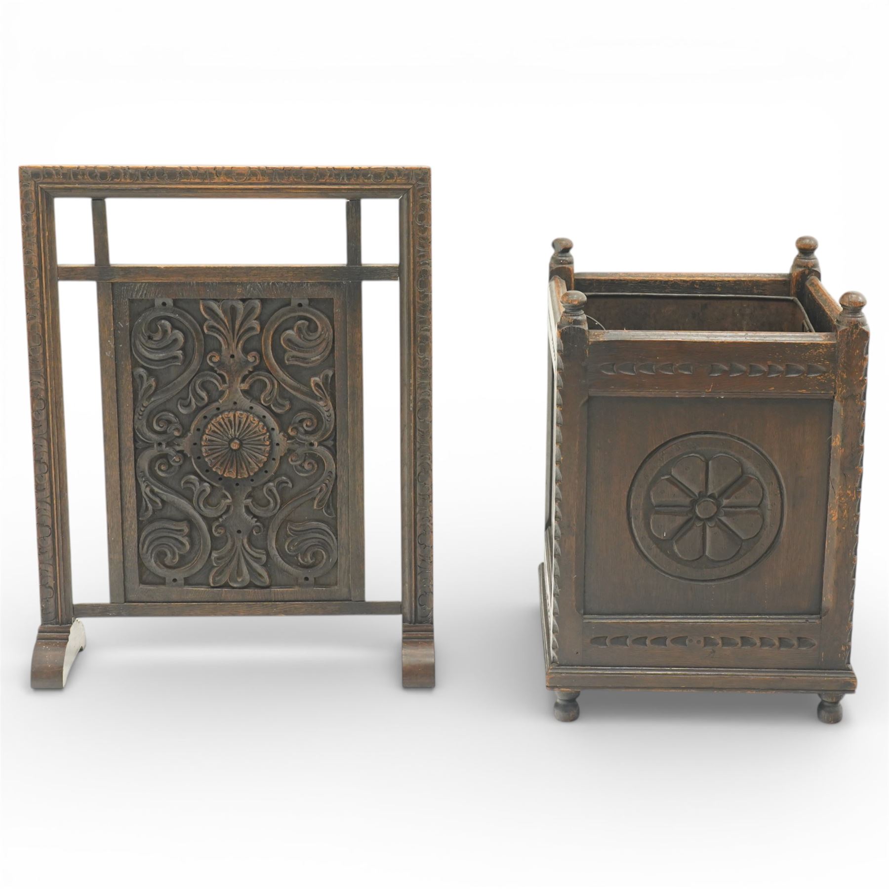 20th century carved fireside accessories; a carved coal bucket with metal liner and a carved fire screen