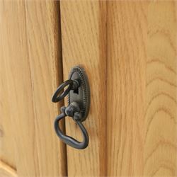 Contemporary oak sideboard, with rectangular top above three drawers and three cupboard doors, blackened metal handles, raised on stile supports