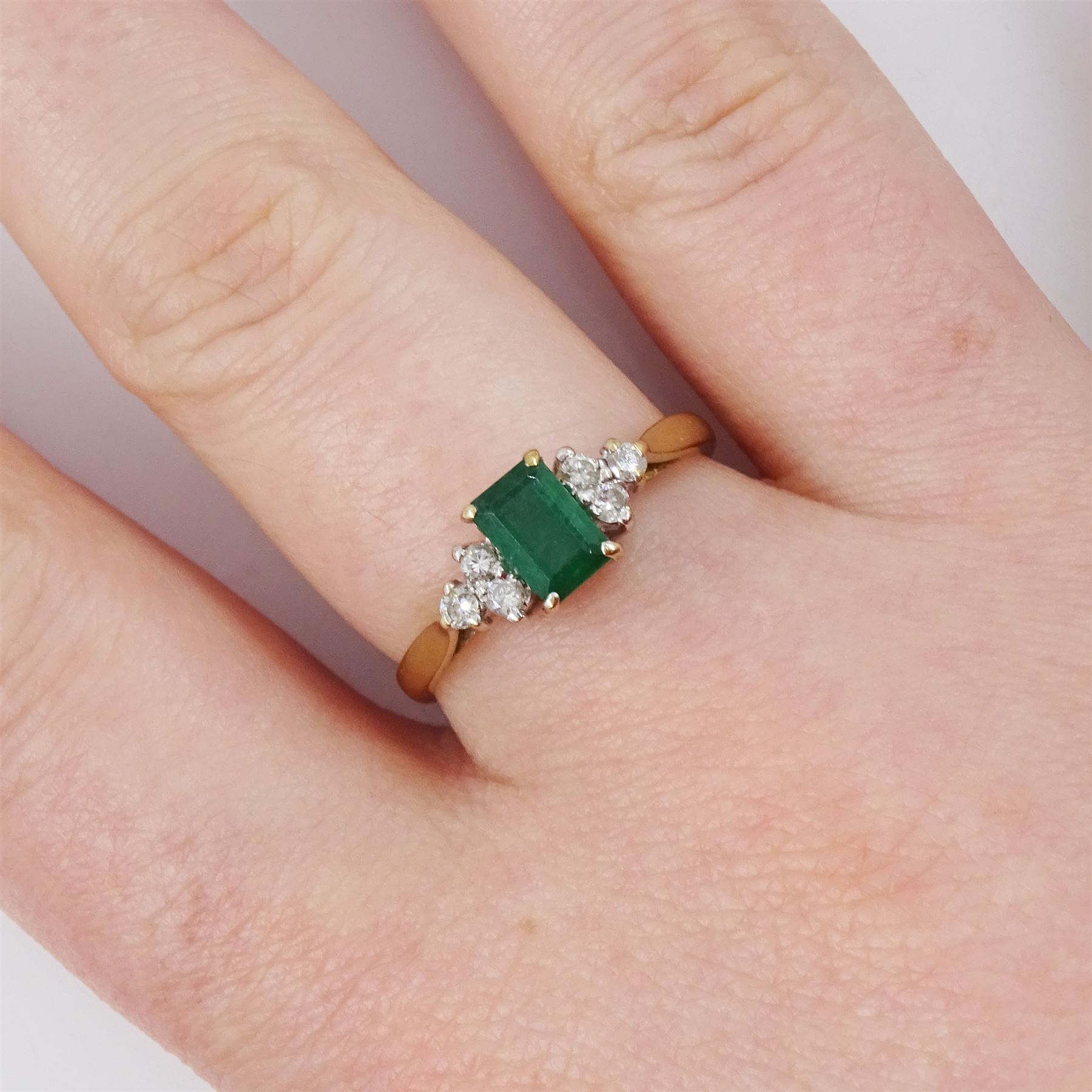 9ct gold emerald and diamond ring, single octagonal cut emerald of approx 0.45 carat, set between brilliant cut diamond trefoil shoulders