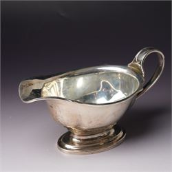 Victorian silver sauce boat engraved with a monogram Sheffield 1892 Maker John Round  & Son Ltd, another with crimped rim Birmingham 1912 Maker Elkington & Co, two silver pepperettes and a small silver challenge cup