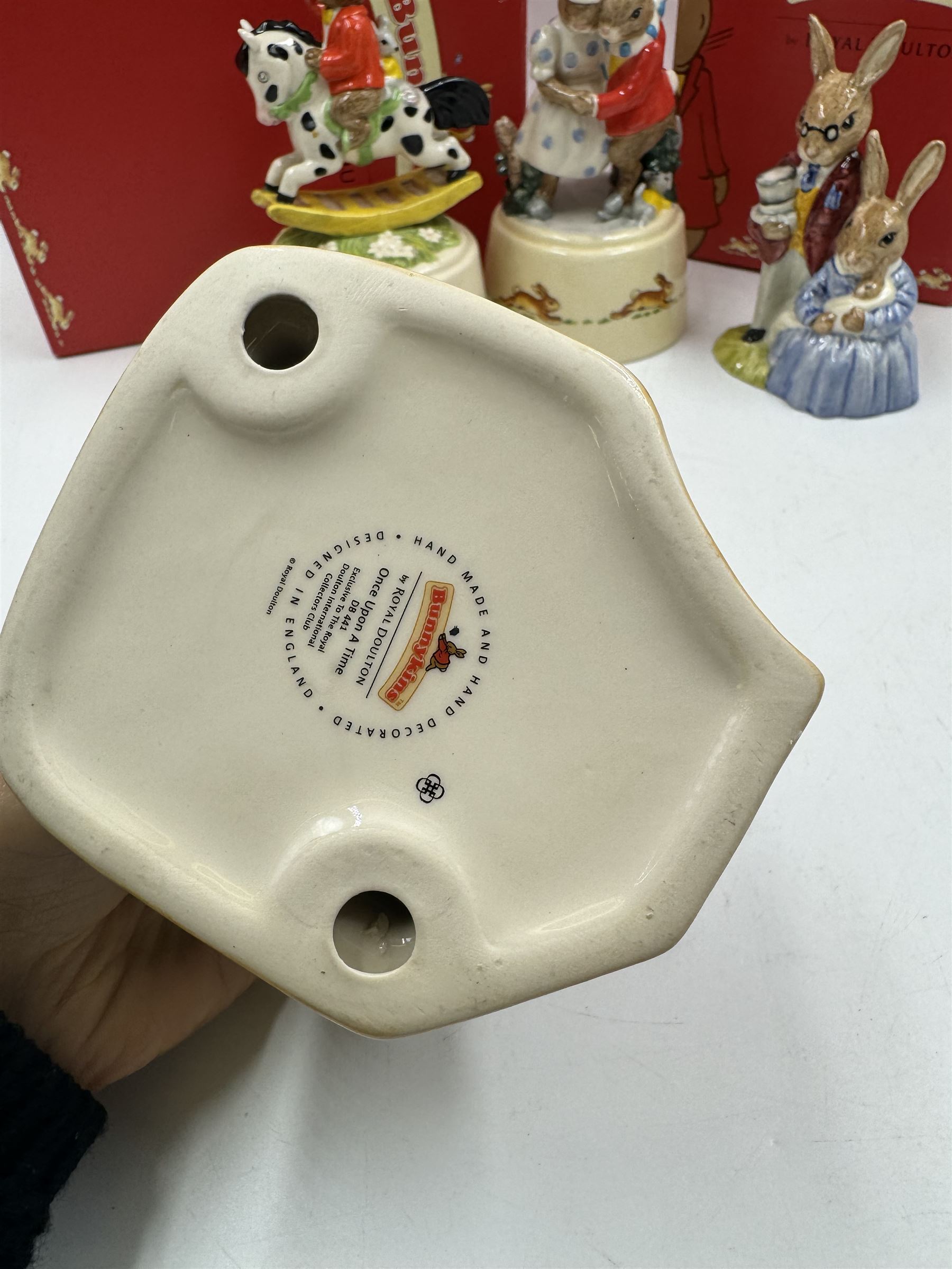 Two Royal Doulton Bunnykins music boxes, comprising Rocking Horse and Winter Waltz together with two Royal Doulton Bunnykins figures Once Upon a Time and Father, Mother & Victoria, all with original boxes  