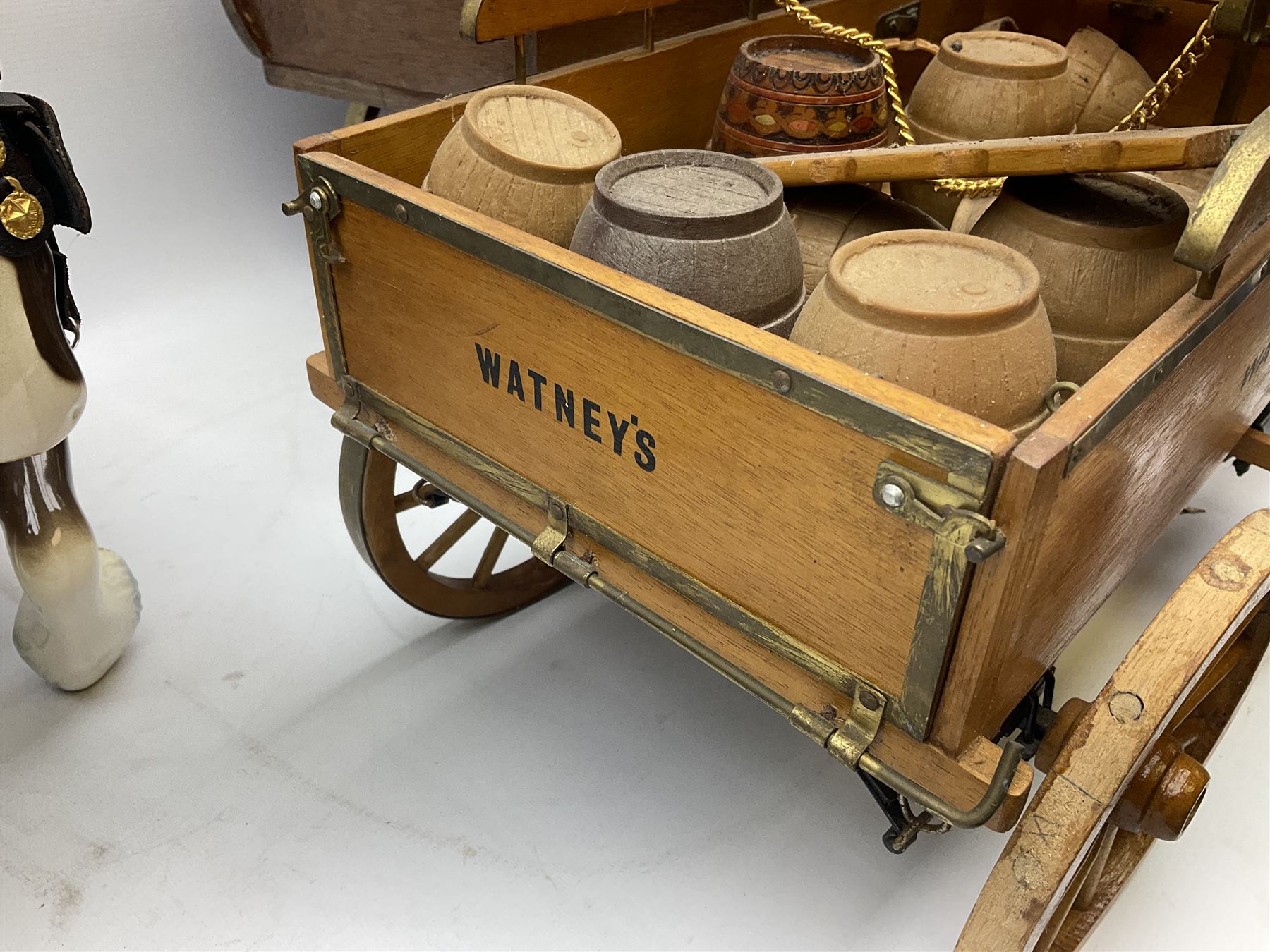 Four Melba Ware Shire horse figures and another similar, and three wood carts