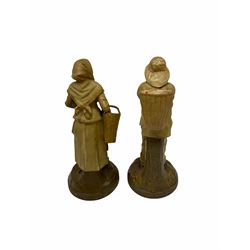 Royal Dux figure modelled as a fish seller, with applied triangle mark to the base and impressed model number 2292, H27cm, together with three Royal Dux style elephants, and a pair of Austrian Turn Wien figures, each carrying 'striker' baskets for matches. 