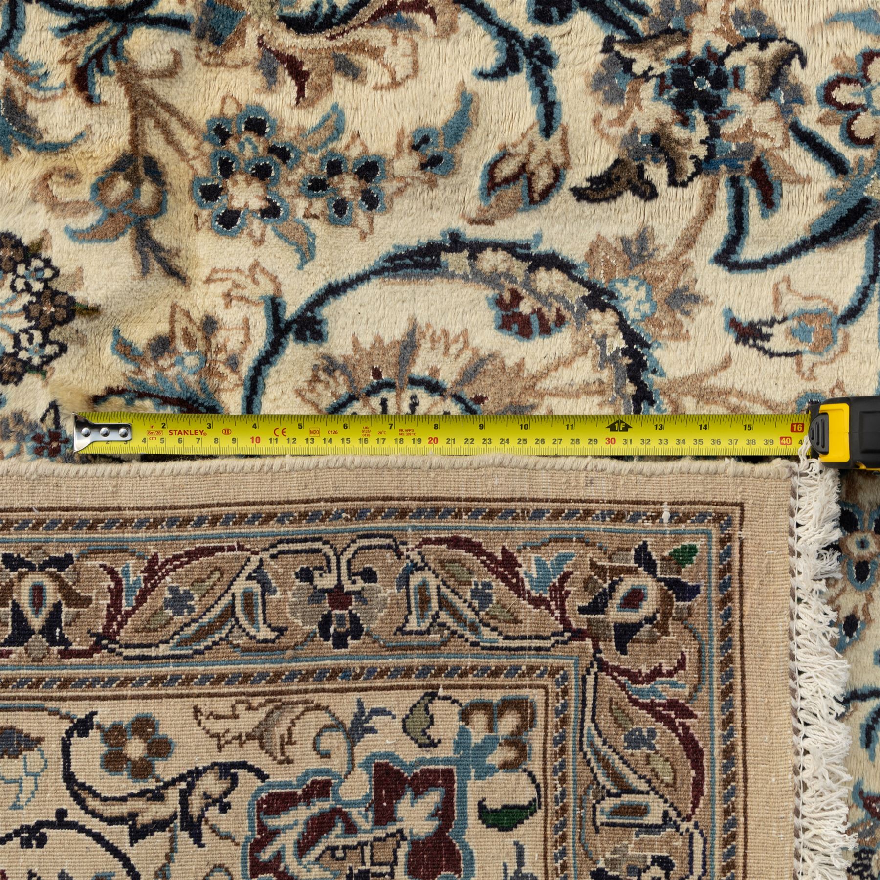 Persian Nain carpet, ivory field with concentric medallion in shades of blue and beige, surrounded by scrolling vines, palmettes and floral sprays, enclosed by multiple borders with intricate foliate motifs, originating from the Nain region of central Iran