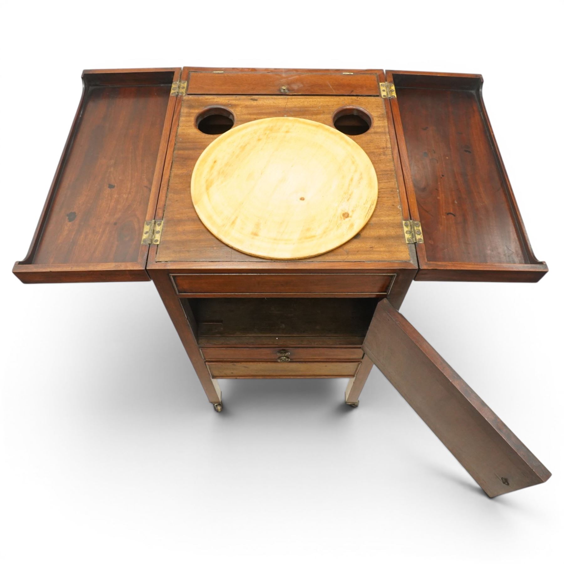 George III mahogany gentleman's washstand, rectangular double-hinged top enclosing fitted interior, over pot cupboard and two cock-beaded drawers, on square supports with castors