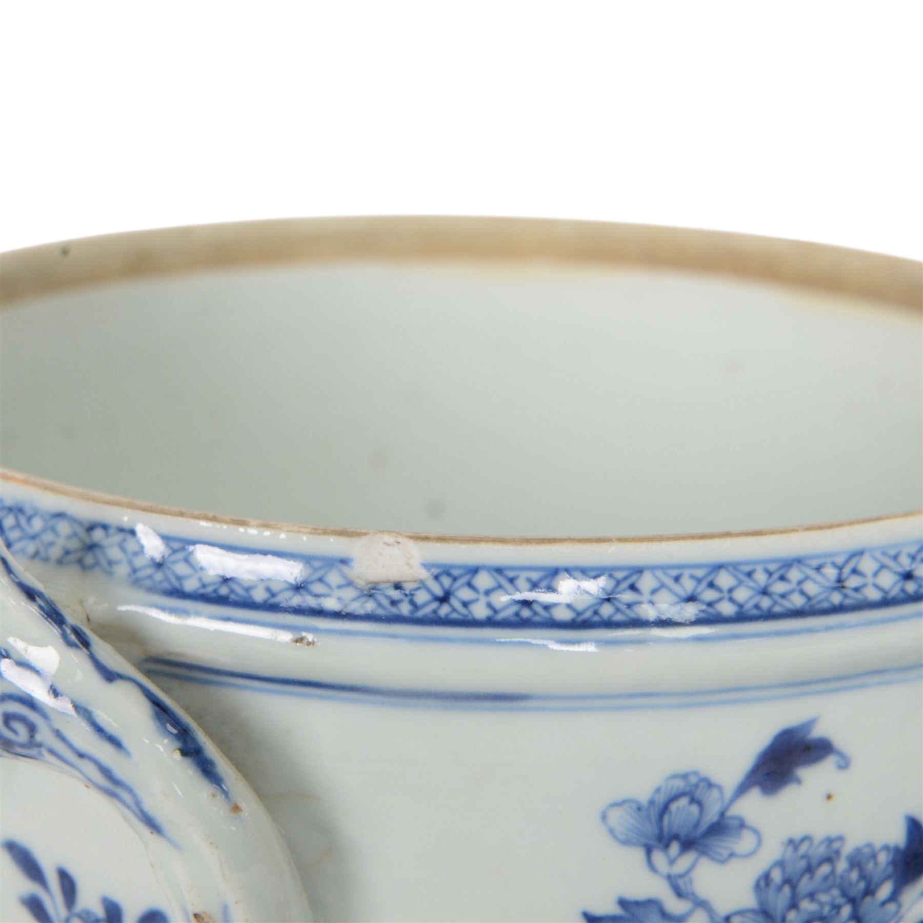 Late 18th/early 19th century Chinese export blue and white tureen and cover, the body with twin curved handles, the pieced and domed cover with multi flower head finial, painted with peonies, rockwork, and fences, overall H26.5cm D22cn 