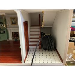 'The Hollies' - good quality sectional wooden doll's house in the form of a Georgian style four-storey bay windowed town house with simulated brick front elevation, rendered sides, off-set corner stonework, faux slate-hung top floor with flat roof and chimney stack, working sash windows, iron railings around front basement courtyard with hinged front elevation to two rooms with  spiral staircase, side hinged central section approached by external steps with iron balustrades to the sides leading to a front door, entrance hall with stairs to landing and two rooms on two floors with dado panelling and fire-surrounds, the top floor with top hung front elevation revealing stairs to a landing and bedroom; wired for electricity L51cm D65cm H107cm including chimney; together with a good quantity of quality wooden furniture and accessories including piano, dressers, bookcase and books, rugs, double half-tester bed, metalware, pictures etc