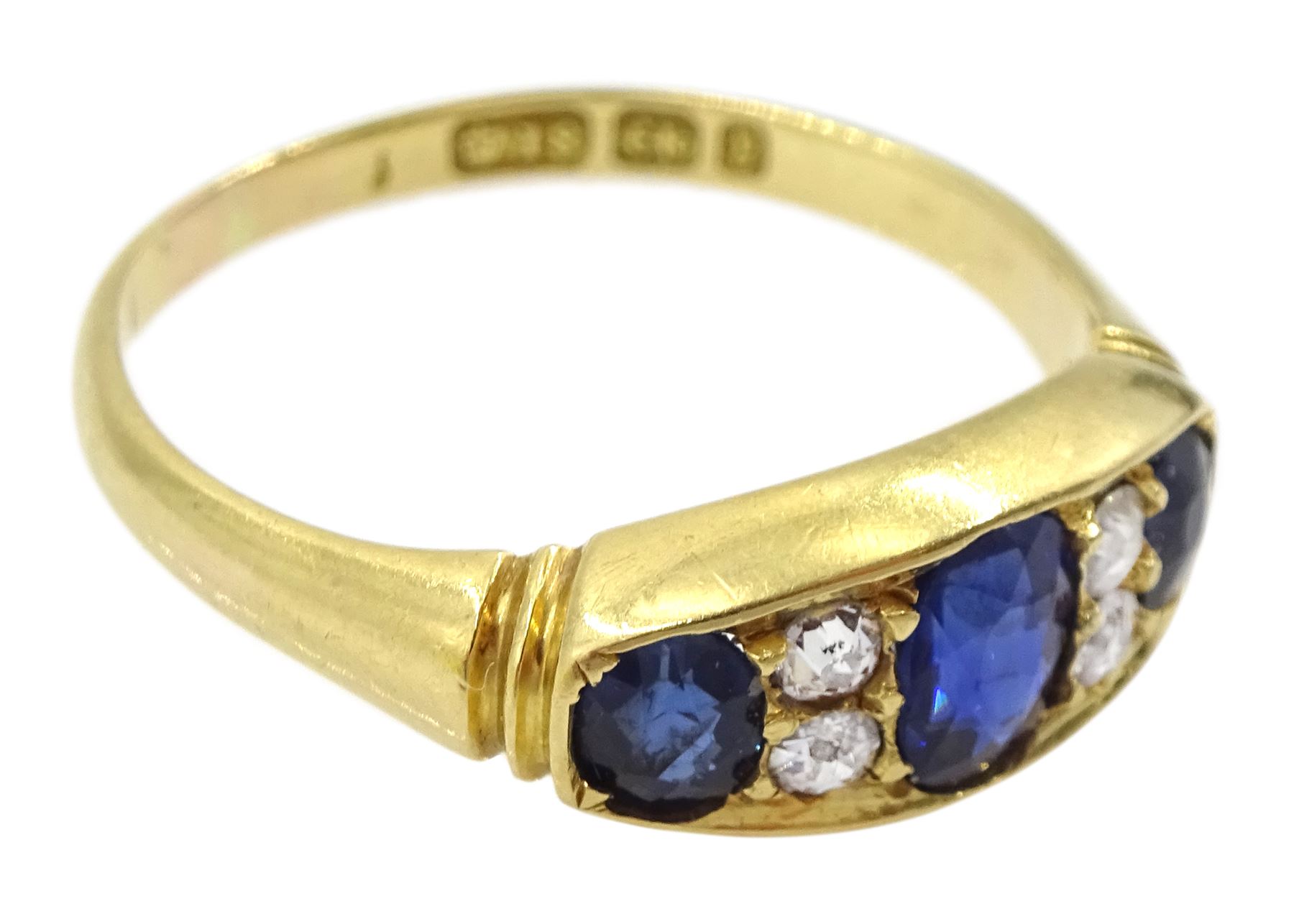 Victorian 18ct gold three stone oval sapphire ring, the central sapphire with two old cut diamonds set either side, Birmingham 1898, total sapphire weight approx 1.00 carat