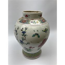 A large Chinese provincial style vase, of baluster form decorated with peonies, butterflies and birds upon a white ground, H35cm. 