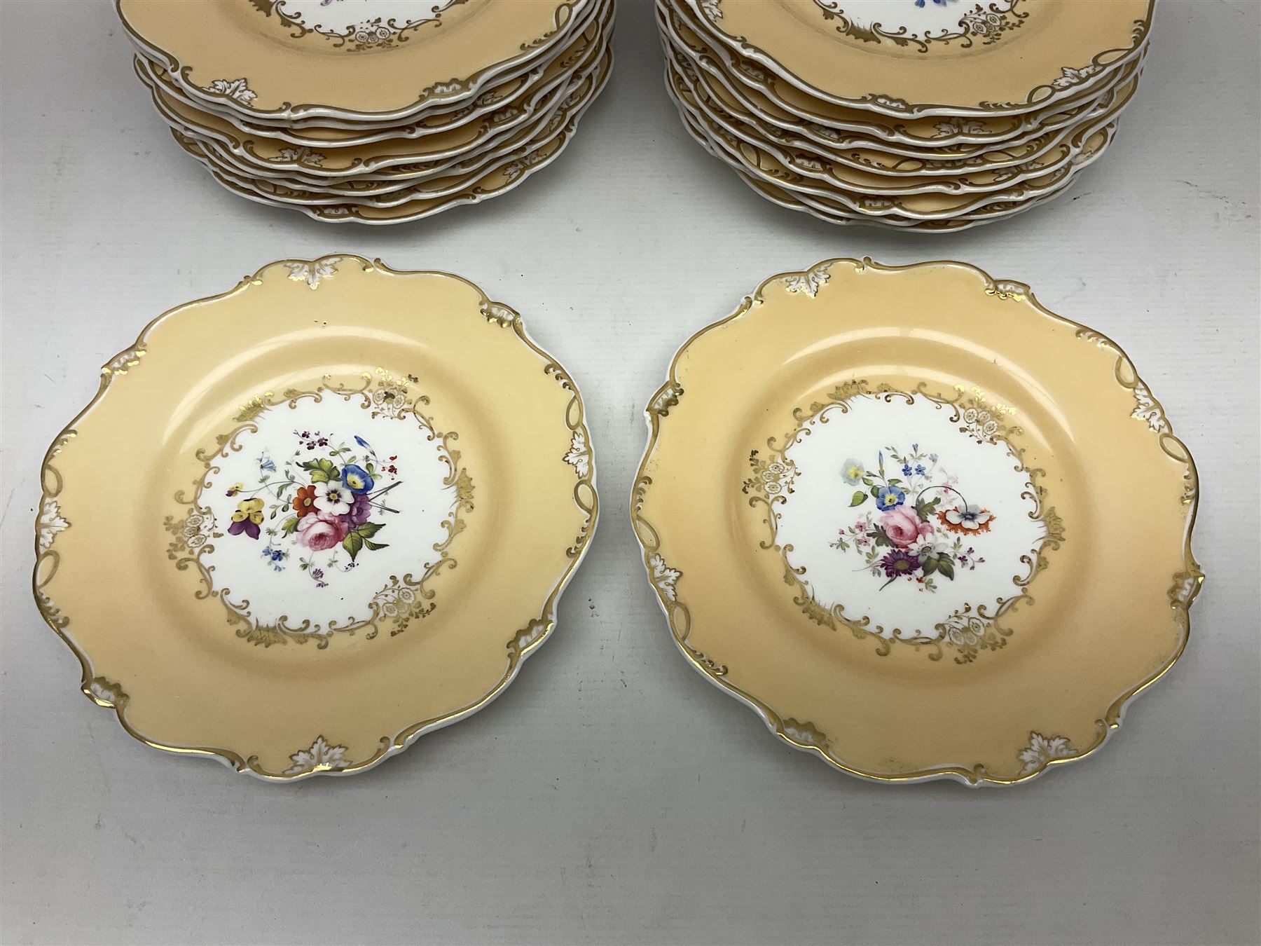 Victorian part dessert service, including eighteen plates, four small serving dishes, shallow dish, etc hand painted with floral sprigs within a cream border with floral panels, and heightened in gilt (26cm)