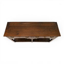 George III oak dresser base, rectangular top with moulded edge, fitted with two drawers over shaped spandrels, raised on square chamfered supports united by undertier, on stile feet