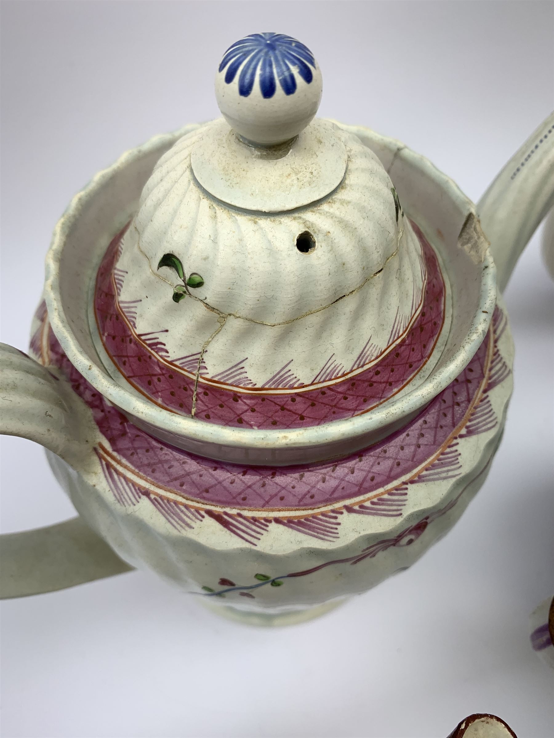 Two19th century relief moulded Castleford teapots, and lidded sucrier, largest teapot H14.5cm, together with three 18th century New Hall type teapots, an early 18th century saucer, and an 18th century blue and white bowl.