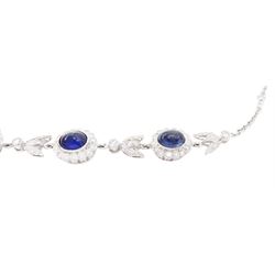 18ct white gold sapphire and diamond milgrain set necklace, oval cabochon cut sapphire surrounded by eight round brilliant cut diamonds and eight French cut sapphires, suspending from a diamond set leaf pendant, single round brilliant cut diamond and a larger old cut diamond, the chain set with six graduating cabochon cut sapphires, each surrounded by diamonds and spaced by a single diamond and a diamond set leaf, to a belcher link chain necklace, hallmarked, total sapphire weight approx 27.00 carat, total diamond weight approx 7.50 carat