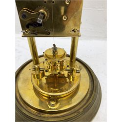 Gustav Becker 400-day torsion clock, serial No 2056379, with an adjustable rotary torsion pendulum and intact suspension, with a circular brass base and glass dome, cream enamel dial with roman numerals, minute markers and steel spade hands.

