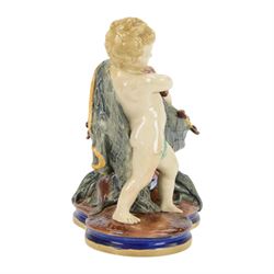 Late 19th century Copeland majolica centrepiece, circa 1874, modelled as two putto standing with fishing net draped between them, their catch spilling onto the quatrelobed base beneath, with impressed mark beneath, H24cm W33cm 