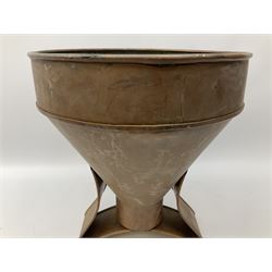 Agricultural copper corn funnel, H32.5cm, another similar copper funnel and copper warming platter of oval form, with twin handles on four supports, with removeable warming plate, L49cm